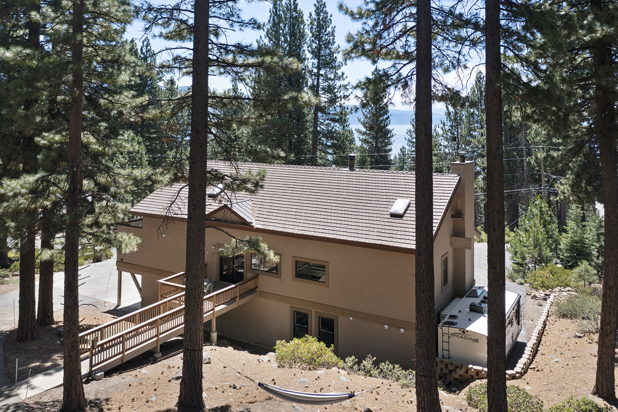 Side view of Kinpine House surrounded by pine trees