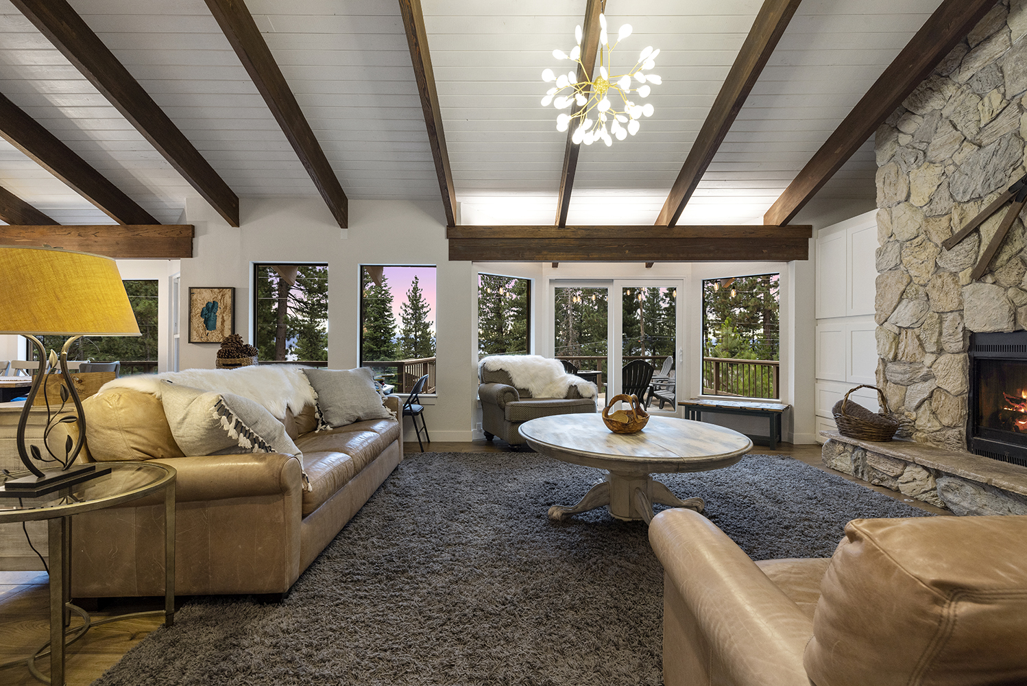Cozy lake-view living room at Kinpine House during golden hour
